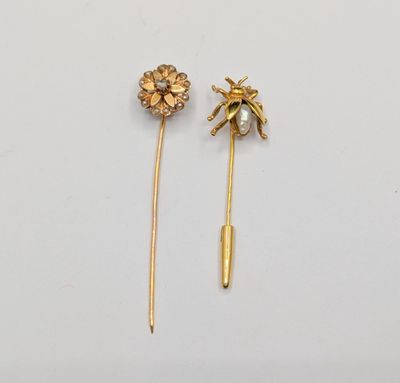 a pair of gold - plated pins with flowers and pearls