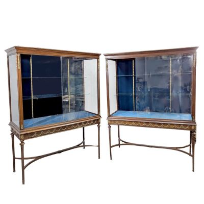 pair of antique display cabinets with glass doors and metal legs