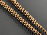 gold plated chain with star links on a black surface