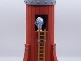 a small toy rocket with a man on the top of it