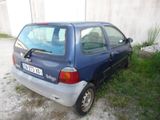 a small blue car that is parked on the side of the road