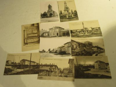 many old postcards of different buildings on the table