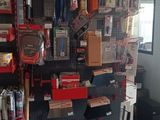 a red shelf with many items on it in a store