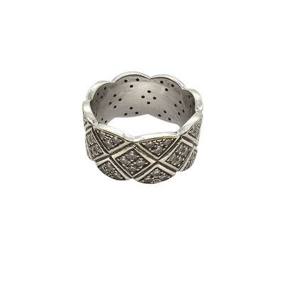 a close up of a silver ring on a white background