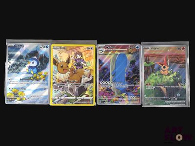 four different pokemon cards are lined up on a black surface