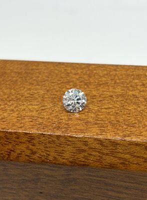 a close up of a diamond sitting on top of a wooden box