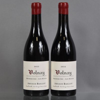 two bottles of red wine sitting on top of a table