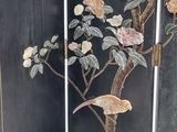 a room divider with a bird and flowers on it