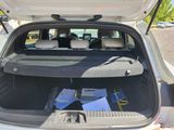 the back of a car with a trunk full of books and papers