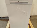 a white dishwasher sitting on a pallet in a room