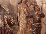 statue of a group of people standing next to a statue of jesus