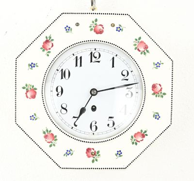 a clock that is hanging on the wall with flowers