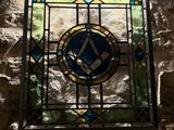 a stained glass window on the wall of a building