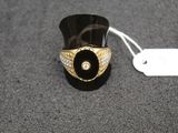 black and gold ring with a white diamond on top