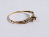 a close up of a gold ring on a white surface