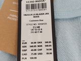 the label on a blue shirt is attached to a brown tag