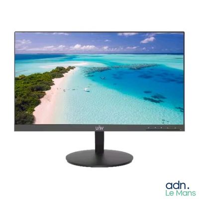 a computer monitor sitting on top of a table next to a beach