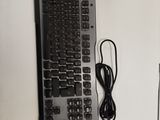 a computer keyboard and a mouse on a desk