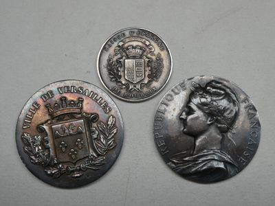 trois pièces d'argent représentant une femme et des armoiries