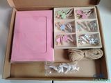 a pink box with clothes pins and a pink box with clothes pins in it