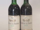 two bottles of wine sitting next to each other on a table