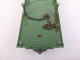 a green box with a chain hanging from it