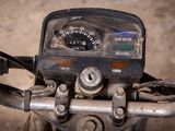 a close up of a motorcycle with a speedometer on it ' s handlebars