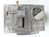 a silver box with a mirror in it on a white surface