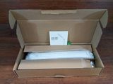 packaging of a box with a white cloth inside of it on a wooden floor