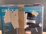 a box of coffee on a table with a cup of coffee in it