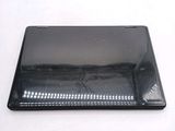 a close up of a black laptop on a white surface