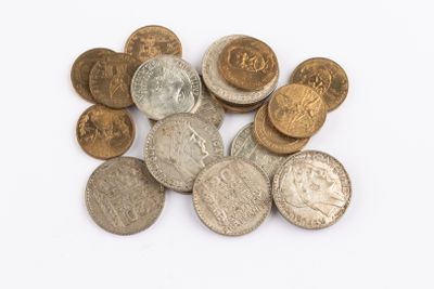 a pile of old coins on a white surface