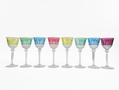six multicolored wine glasses are lined up in a row