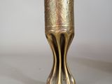 a gold vase that is sitting on a table