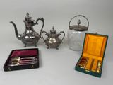 three pieces of silverware including a teapot, spoons, and a teapot