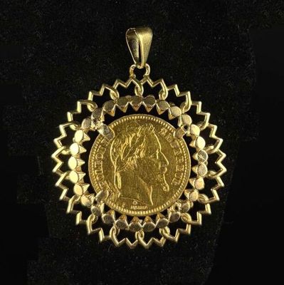a close up of a gold coin on a black surface
