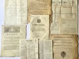 some old papers are sitting on a table with a pen and ink