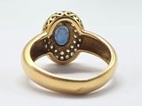 an image of a gold ring with a blue stone in the center