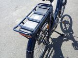 a blue bicycle with a basket on the back of it
