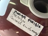 a sticker on the handle of a red mixer