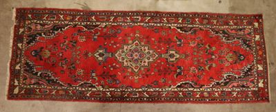 a red rug on a wooden floor with a white background