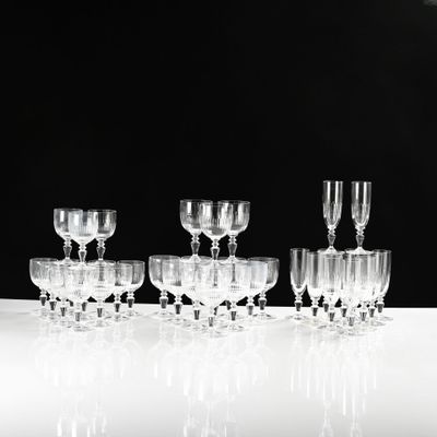 several empty wine glasses are lined up on a white table