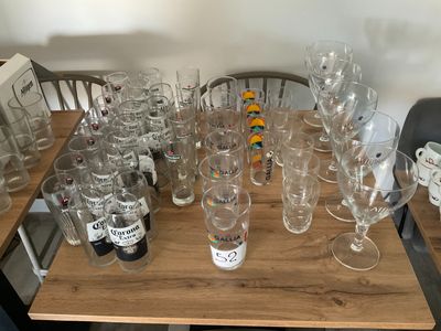 many empty wine glasses sitting on a wooden table