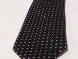 the tie is black and white with small squares on it