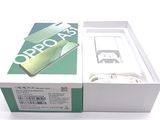 a box with a phone inside of it on a white surface