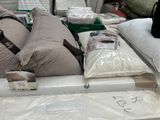 a lot of pillows and blankets on the table