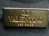 an image of a close up of a metal sign on a piece of luggage