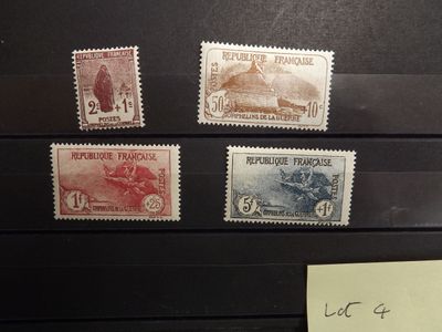 four different stamps on a black box with a note attached to it