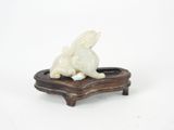 chinese carved ivory figurine of a rabbit on a wooden stand