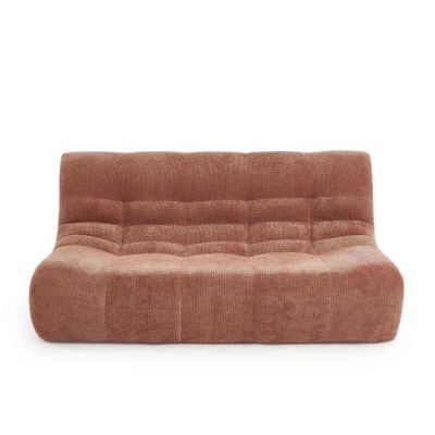 a brown couch sitting on top of a white floor next to a white wall
